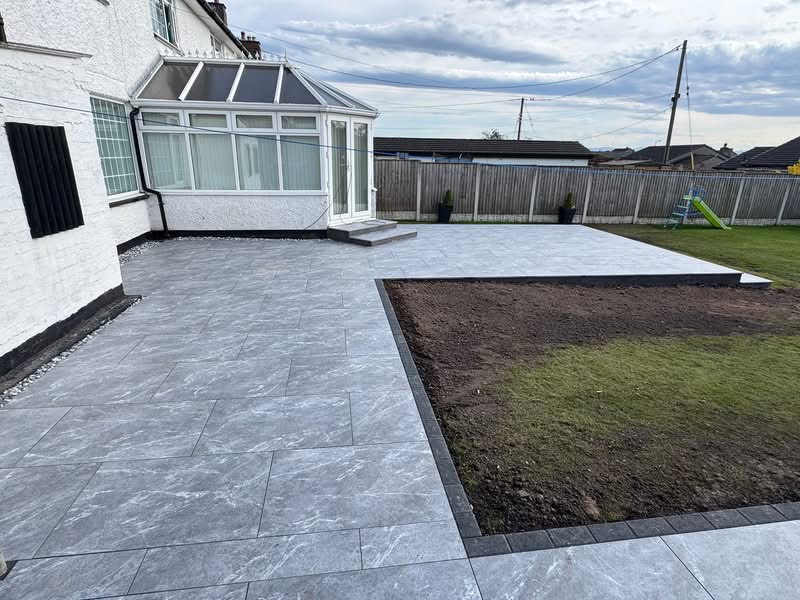 Porcelain patio wrapping the conservatory with new lawn area, Gretna