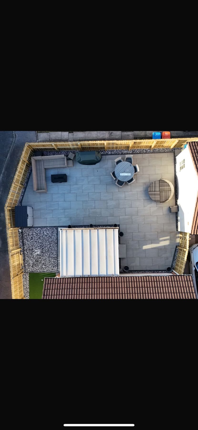 Aerial view of the completed grey porcelain patio with sett border, gravel margins and seating zones