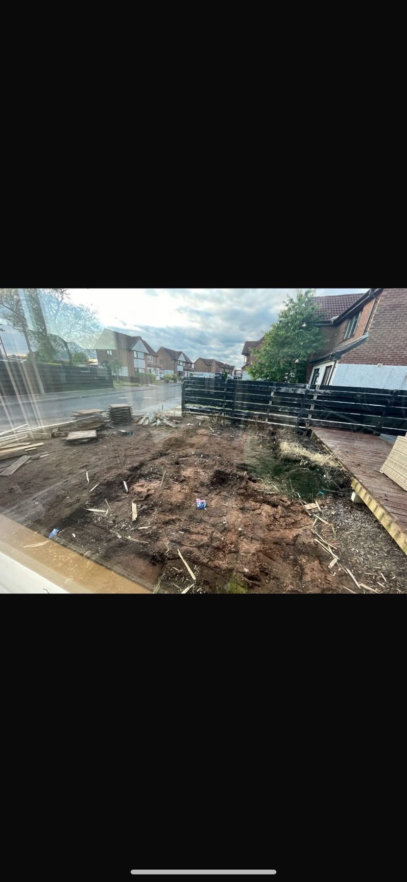 Before — bare soil and builder debris in the new-build rear garden